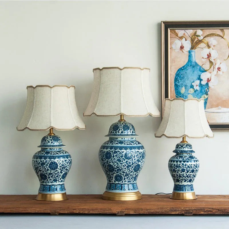 Chinese blue and white porcelain table lamp with cloth shade on wooden surface