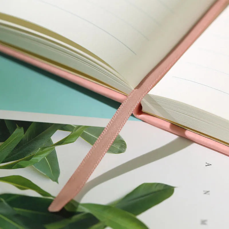 A5 tactile PU hardcover notebook in black with adhesive binding and 100gsm white paper