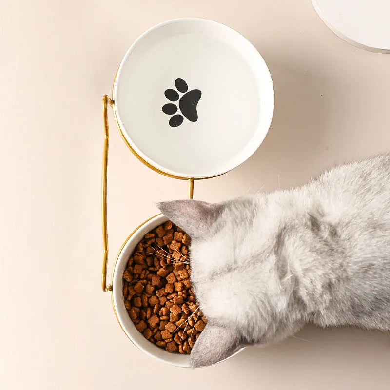 White ceramic cat bowl with decorative pattern and black iron frame support