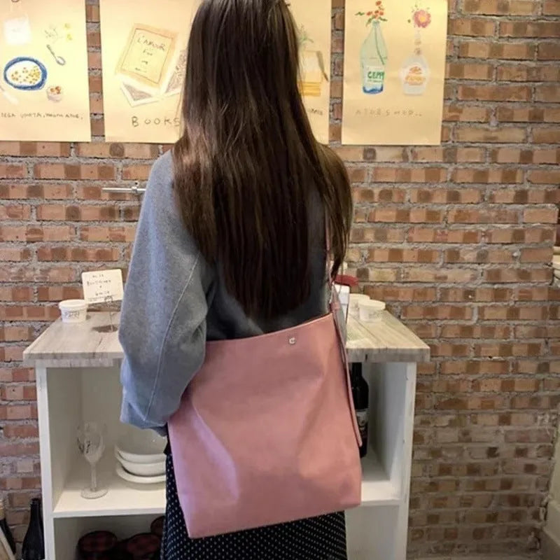 Corduroy one-shoulder commuter bag with pink or brown colour options showing 39cm length dimension