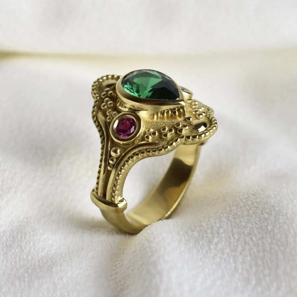Women's geometric fashion ring in golden lvzuan colour on a grey background.