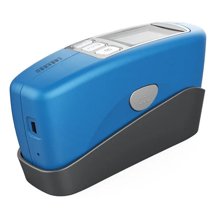 Handheld ceramic brightness stone portable glossiness tester gloss meter on a work surface.