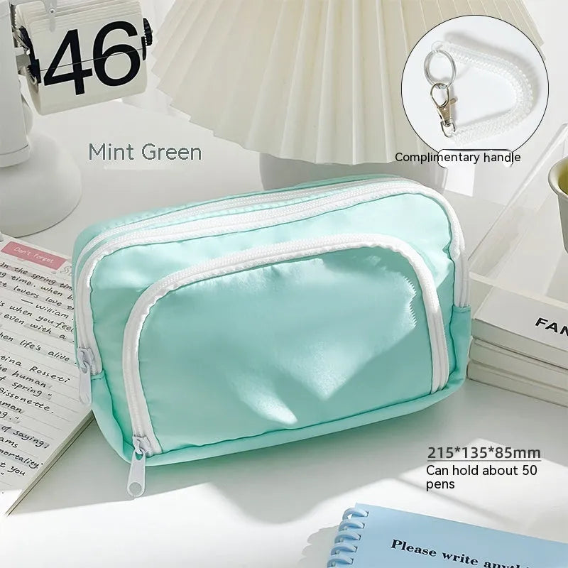 Double layer pencil case in blue, pink, green or cream with gift handle and 215x135x85mm dimensions