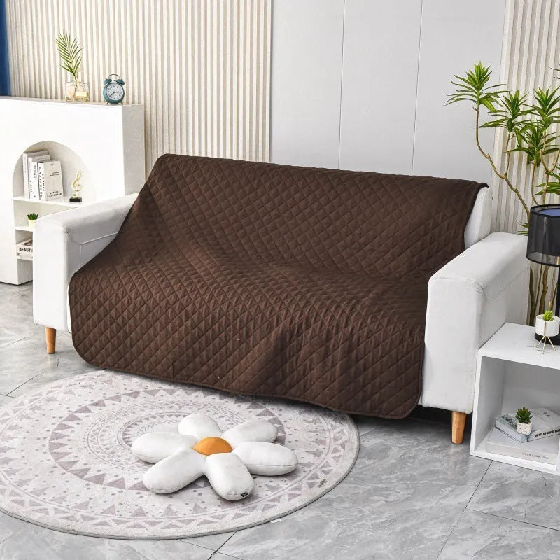 Reversible dog blanket couch cover in grey, laid flat on a sofa