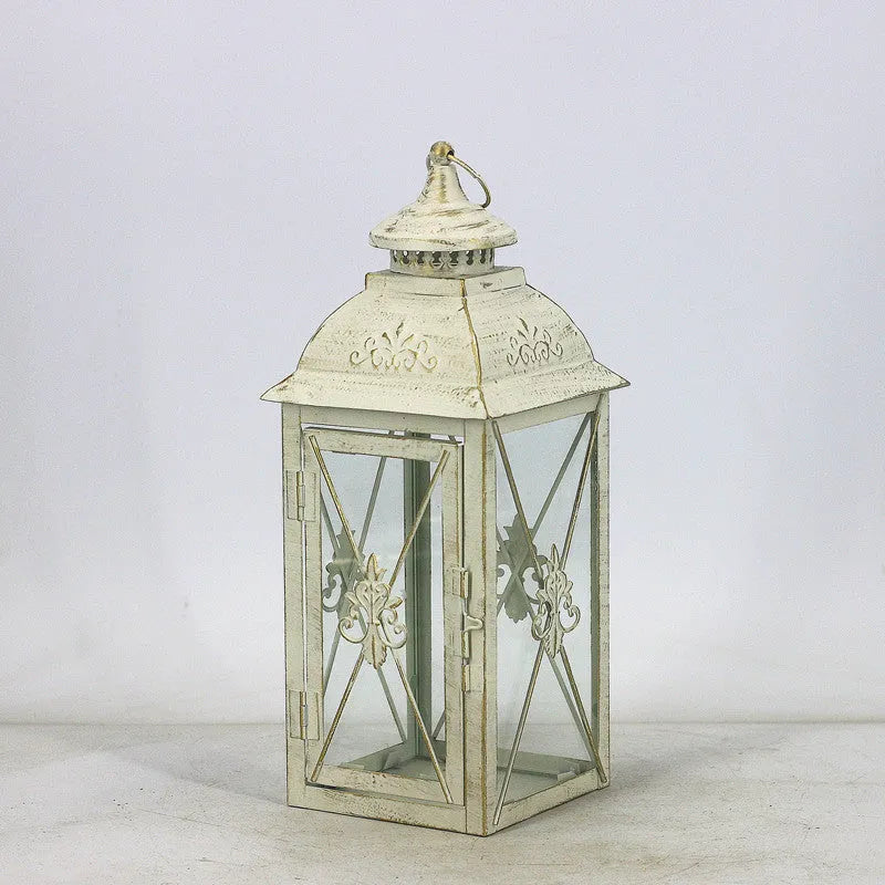 Black and white wrought iron floor-standing storm lantern with tempered glass in three sizes for courtyard use.