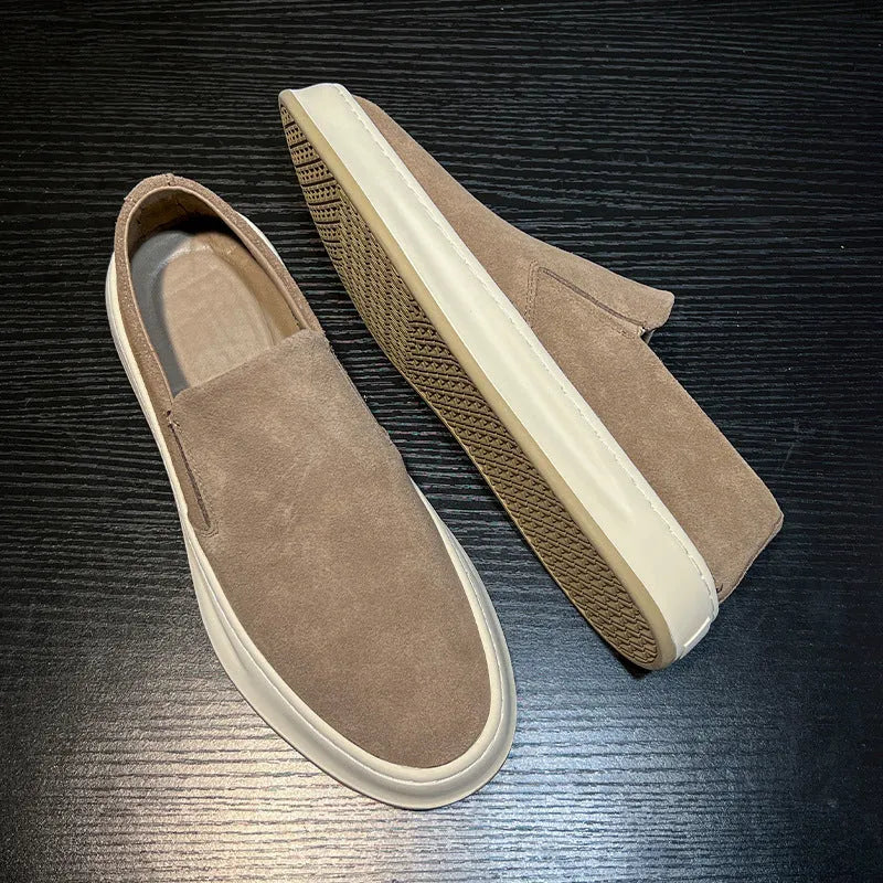 Men's grey slip-on casual shoes with round toe, mid-heel, and visible stitching on a rubber sole.