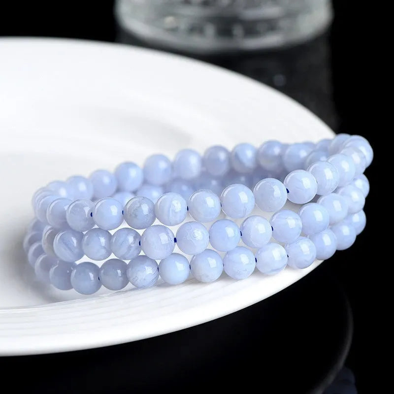 Blue agate bracelet with striped patterns showing 6-6.8mm beads and natural stone colour variations