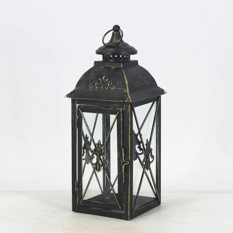 Black and white wrought iron floor-standing storm lantern with tempered glass in three sizes for courtyard use.