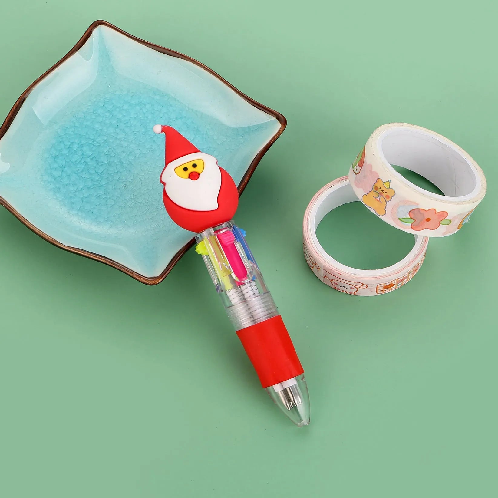 Christmas mini four-colour press-type ballpoint pen showing festive designs, 11cm long.