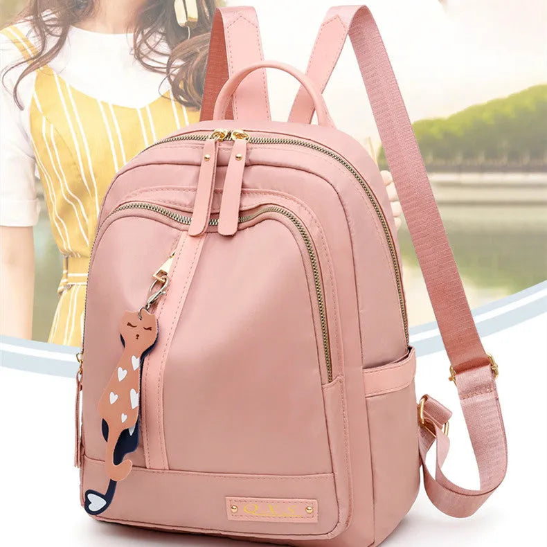 Women's black nylon backpack with square vertical shape showing internal compartments and shoulder straps