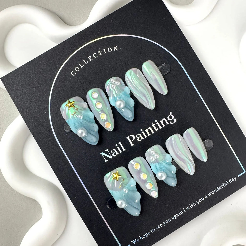 Blue plastic nail stickers and wearable nail armour pieces set on a white background.