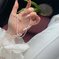White imitation pearl necklace with geometric bow pendant on adjustable 31-40cm chain