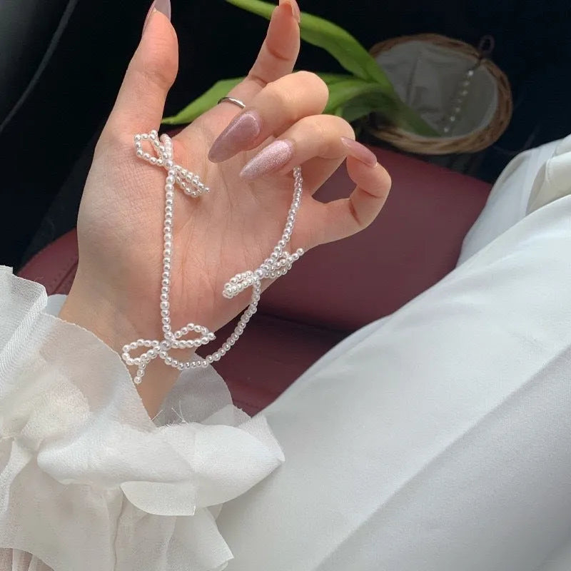 White imitation pearl necklace with geometric bow pendant on adjustable 31-40cm chain