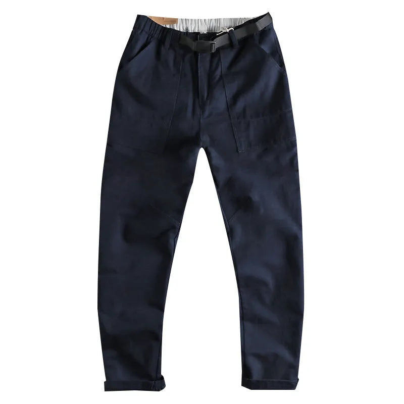 Man's khaki cotton canvas work trousers with 3D cut, showing mid-rise waist and zipper fly.