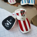 Four blue cloth dog shoes with zipper closures and non-slip soles arranged together