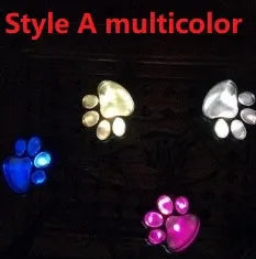 Black solar-powered bear paw print LED garden lights with four paw shapes connected to solar panel
