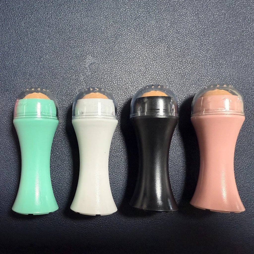 Volcanic stone facial roller in a plastic case for oily skin control, shown in one of four colours.