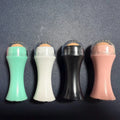 Volcanic stone facial roller in a plastic case for oily skin control, shown in one of four colours.