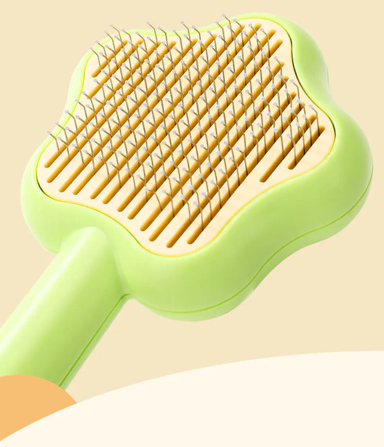 Green self-cleaning cat comb with stainless steel needles measuring 20 cm long