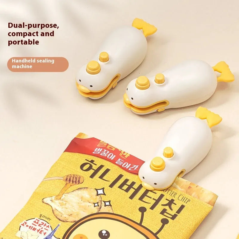 Yellow duck jacquard patterned rechargeable handheld bag sealing machine with USB charging cable.
