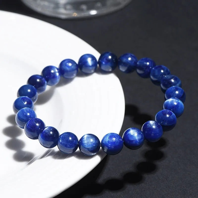 Geometric Ruyi design blue crystal ball bracelet with polished beads on a white background.