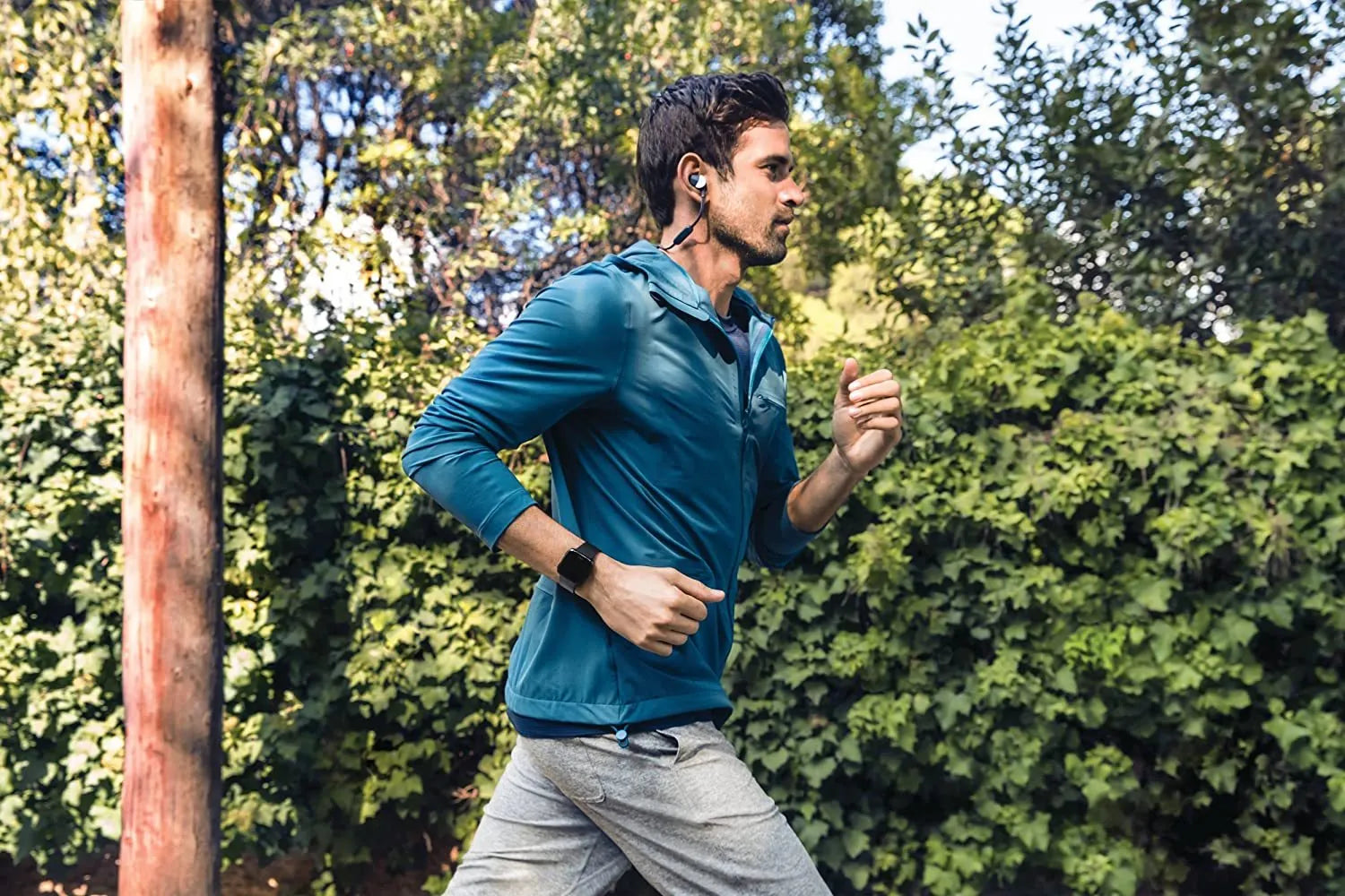 Black smart watch with silicone strap showing a heart rate reading on its 1.4 inch screen.