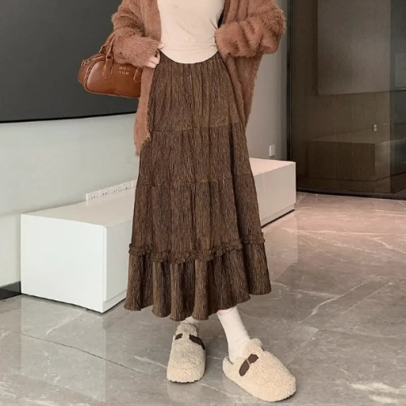 Korean urban style corduroy A-line midi skirt with elastic waistband in milky white colour on a hanger.