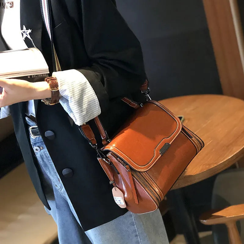 Women's genuine leather messenger bag in horizontal square design with multiple internal compartments