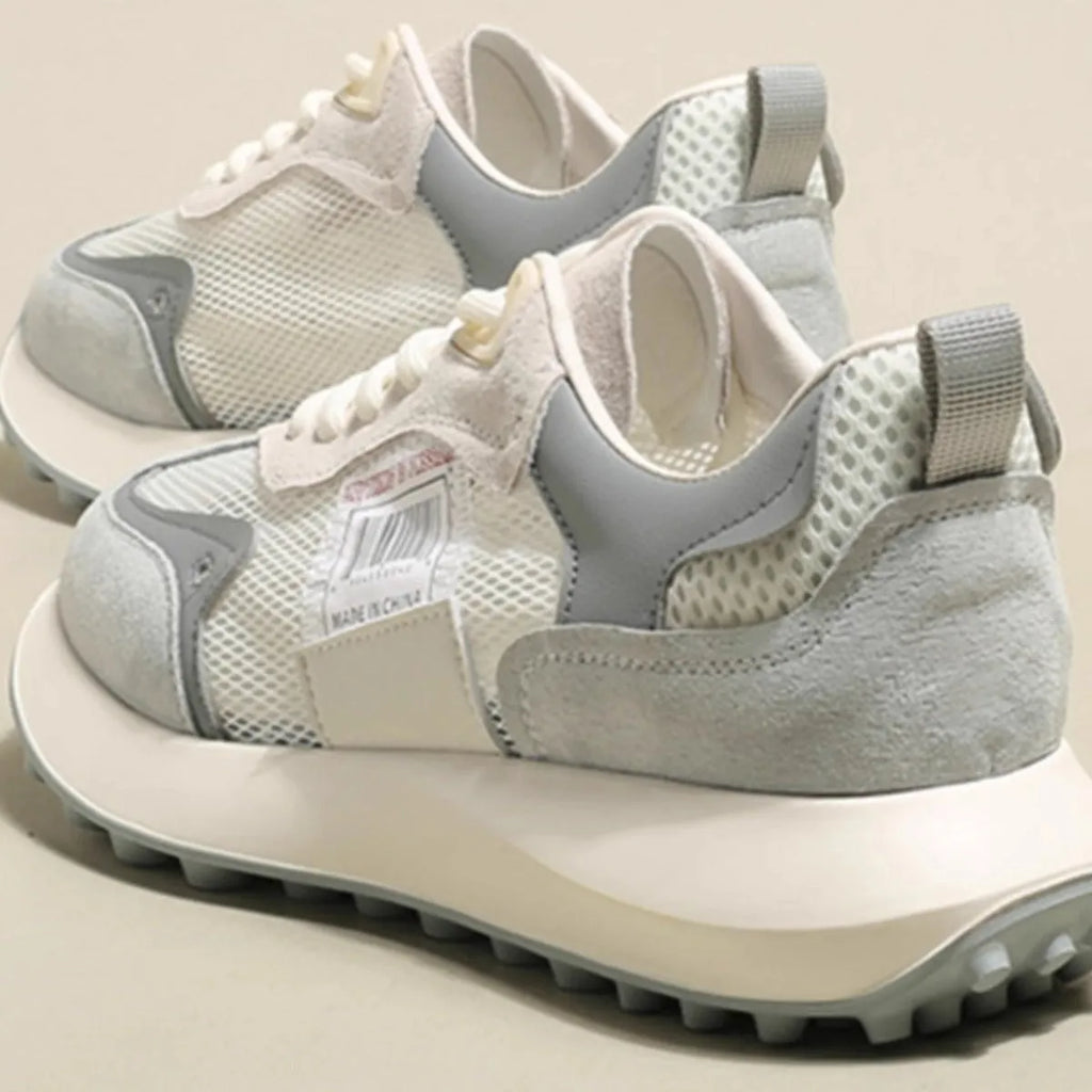 Women's gray and pink retro sneakers with mesh lining, rubber sole, and low-top design