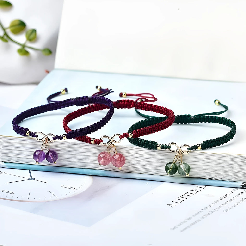 Women's natural strawberry quartz bracelet with detailed cherry charm and crystal beads.