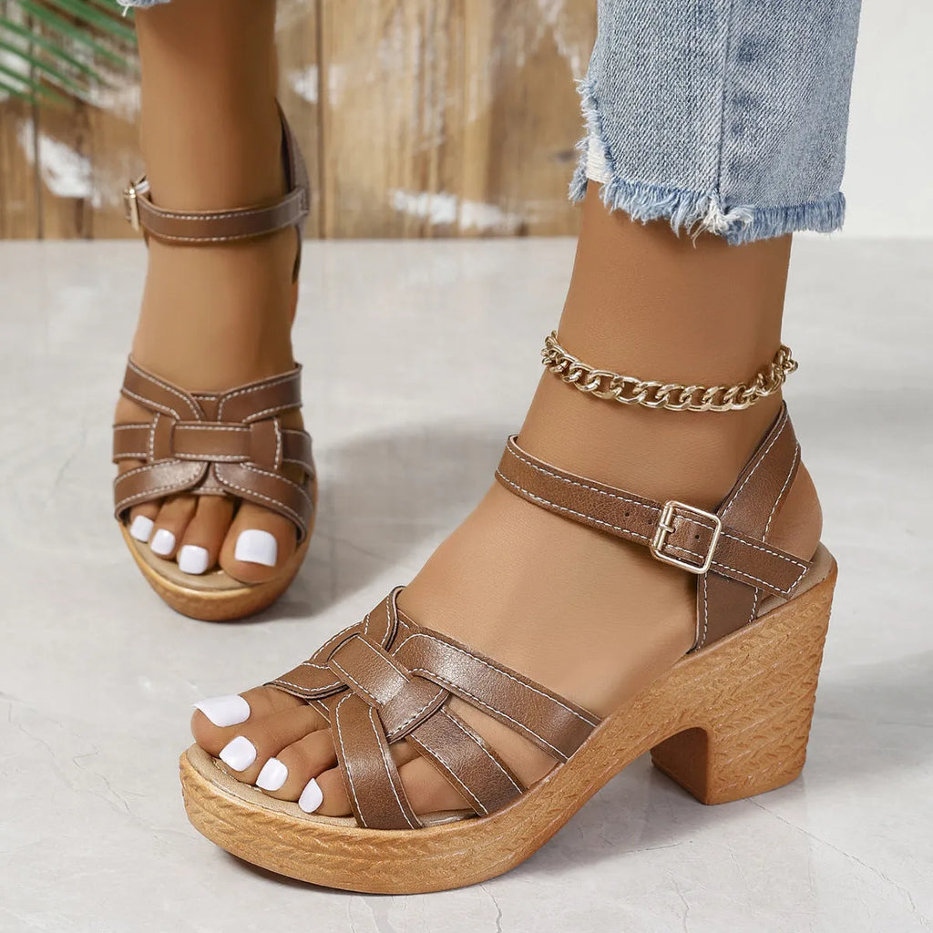 Plus size women's black peep toe sandals with a chunky heel and an ankle-strap buckle closure.