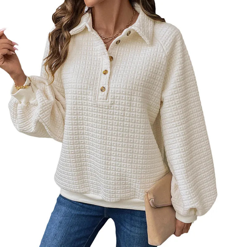 Women's milky white textured polo collar chunky knit sweater laid flat.