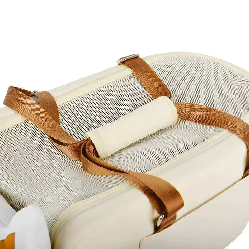 Beige hard-shell portable cat carrier flight case with one-shoulder strap, dimensions 43cm by 25cm by 22.5cm.