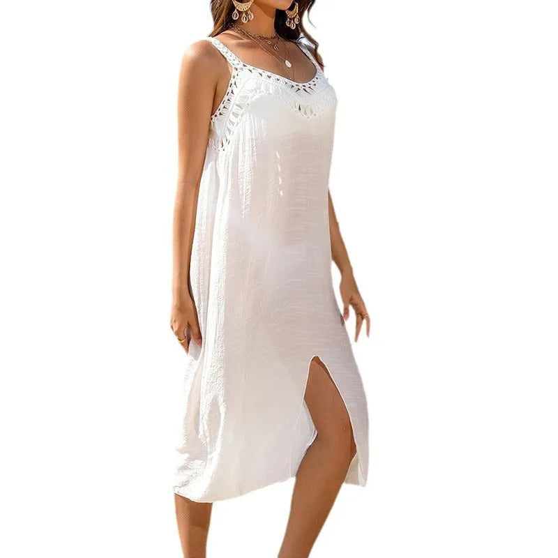 White women's suspender beach dress with crochet detail and a bottom slit hem.