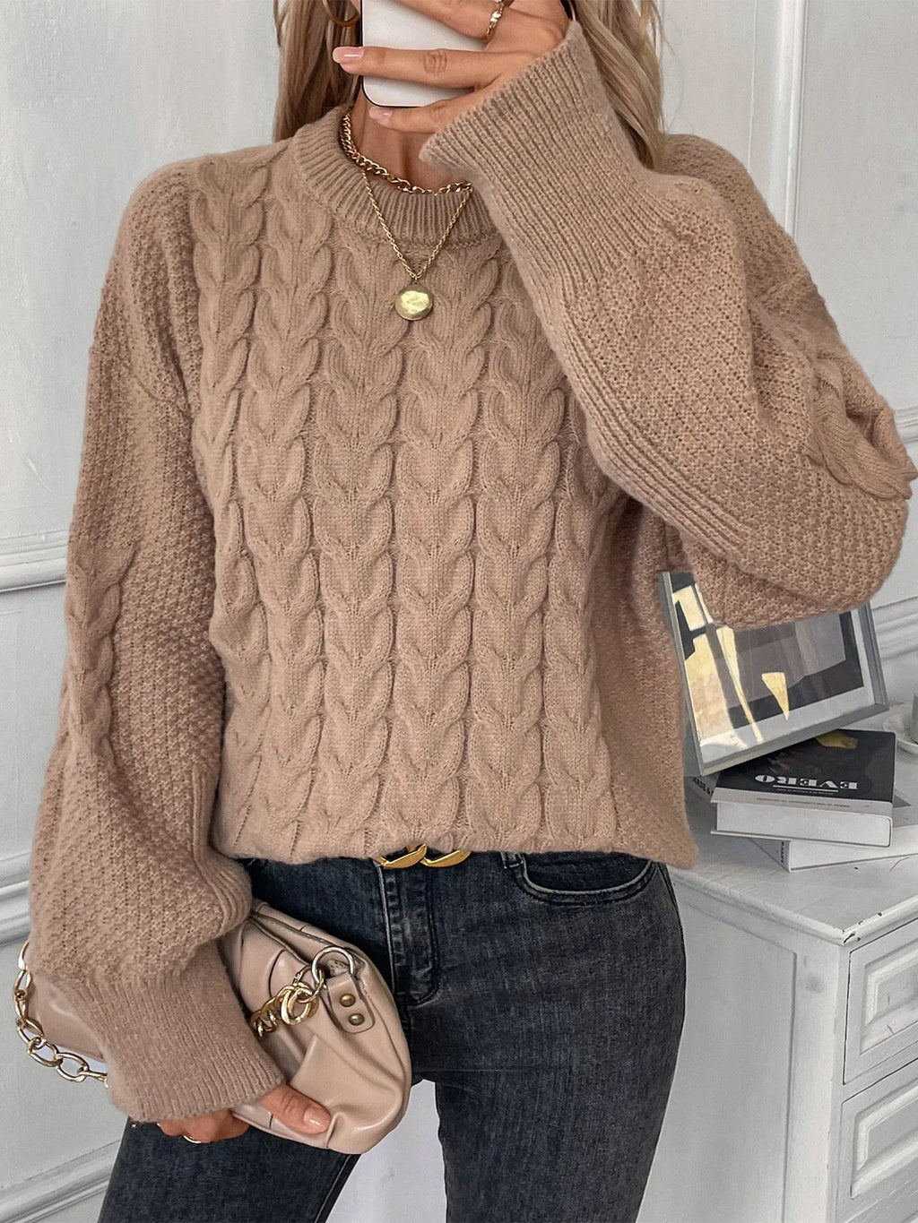 Women's beige loose sweater with round neck and twisted yarn detail on solid polyester fabric