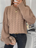 Women's beige loose sweater with round neck and twisted yarn detail on solid polyester fabric