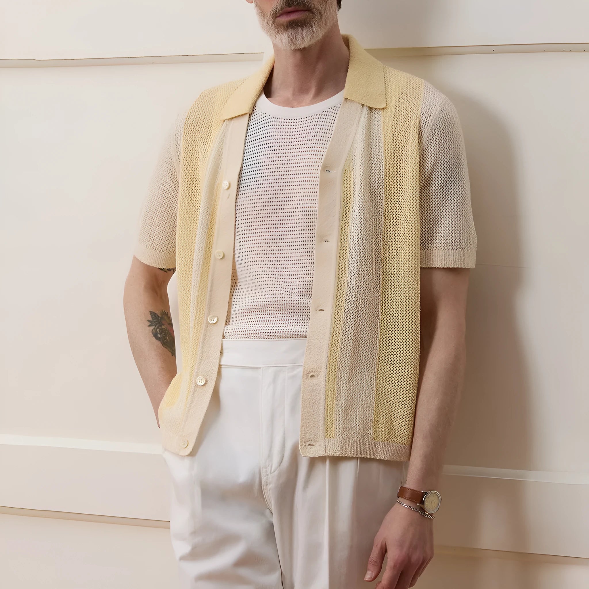 Yellow short-sleeved polo shirt with asymmetric design and hollow-out pattern details
