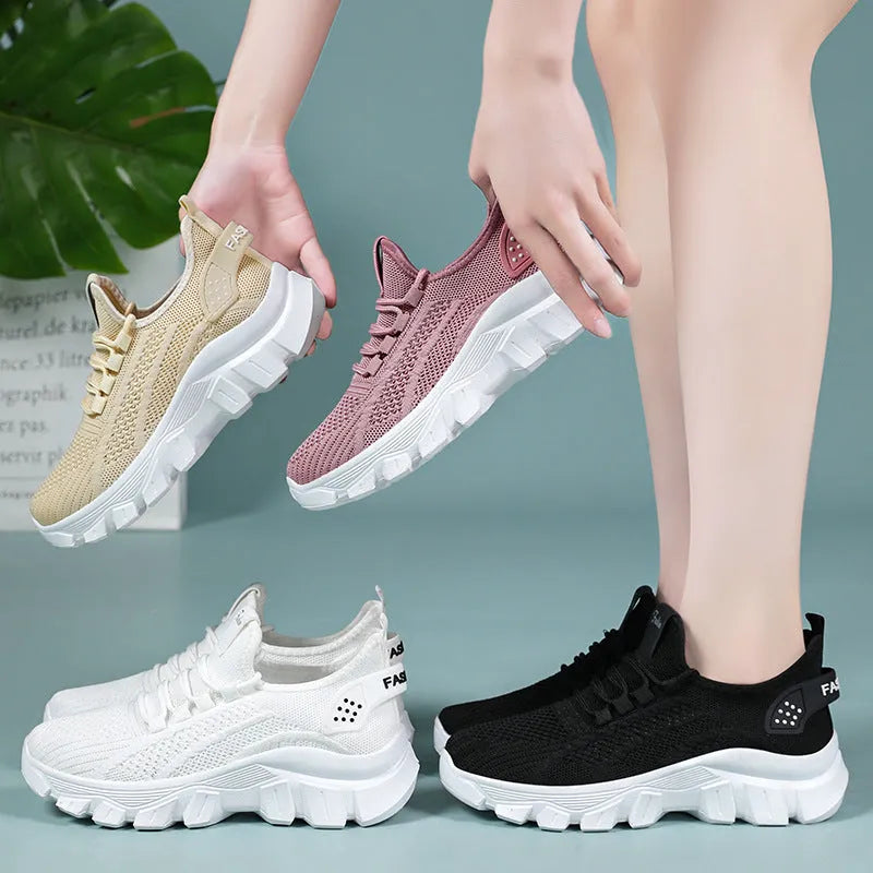 Women's white Flyknit sneakers with thick PVC sole and lace-up design on a neutral background.