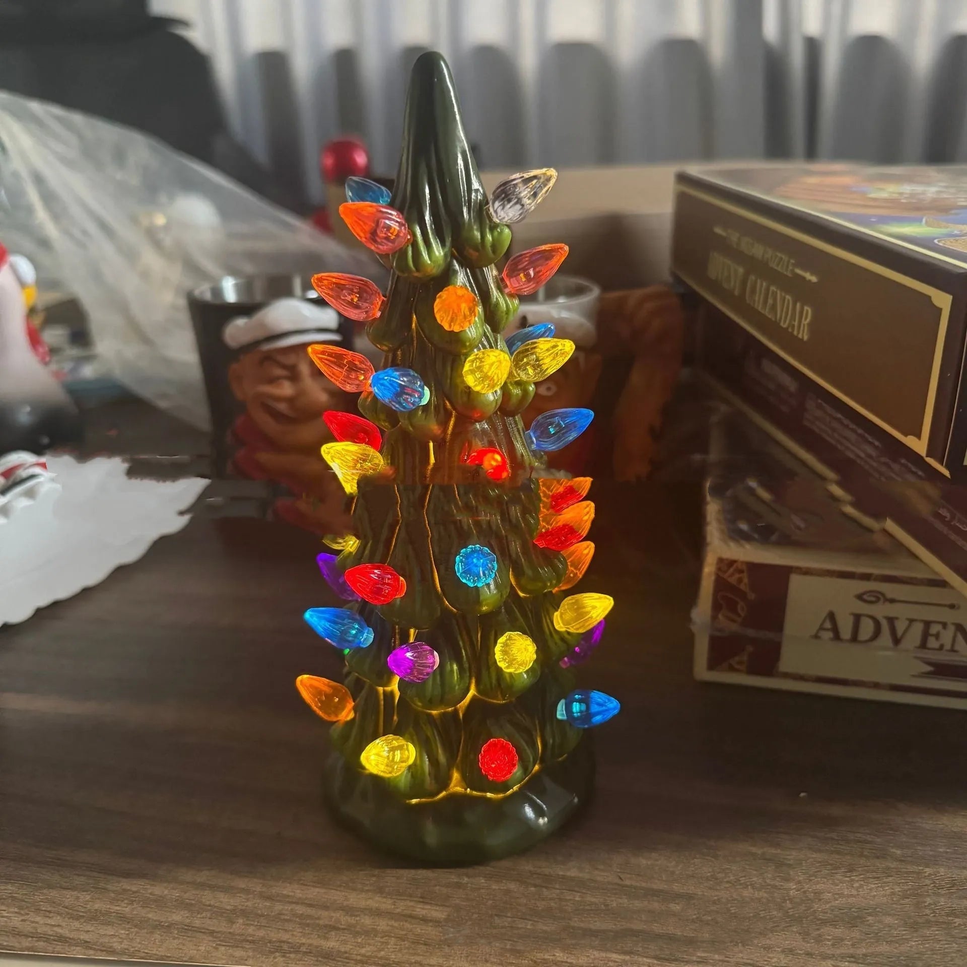 Resin and plastic Christmas tree decorative light ornament in European style, shown in coloured or warm light.