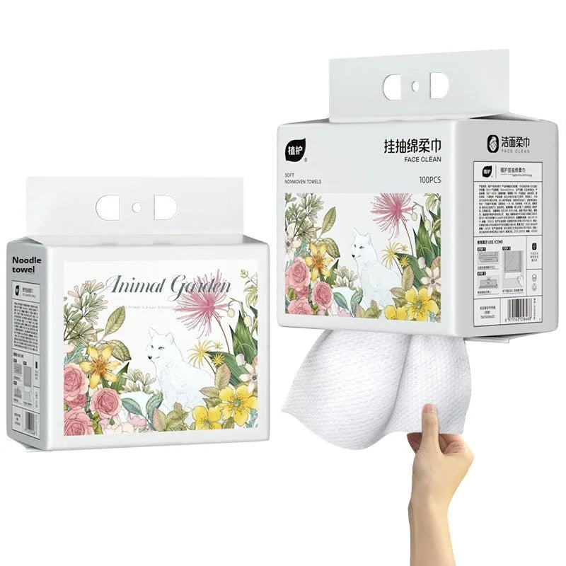 A roll of disposable white face cloths with a removable hook for hanging storage.
