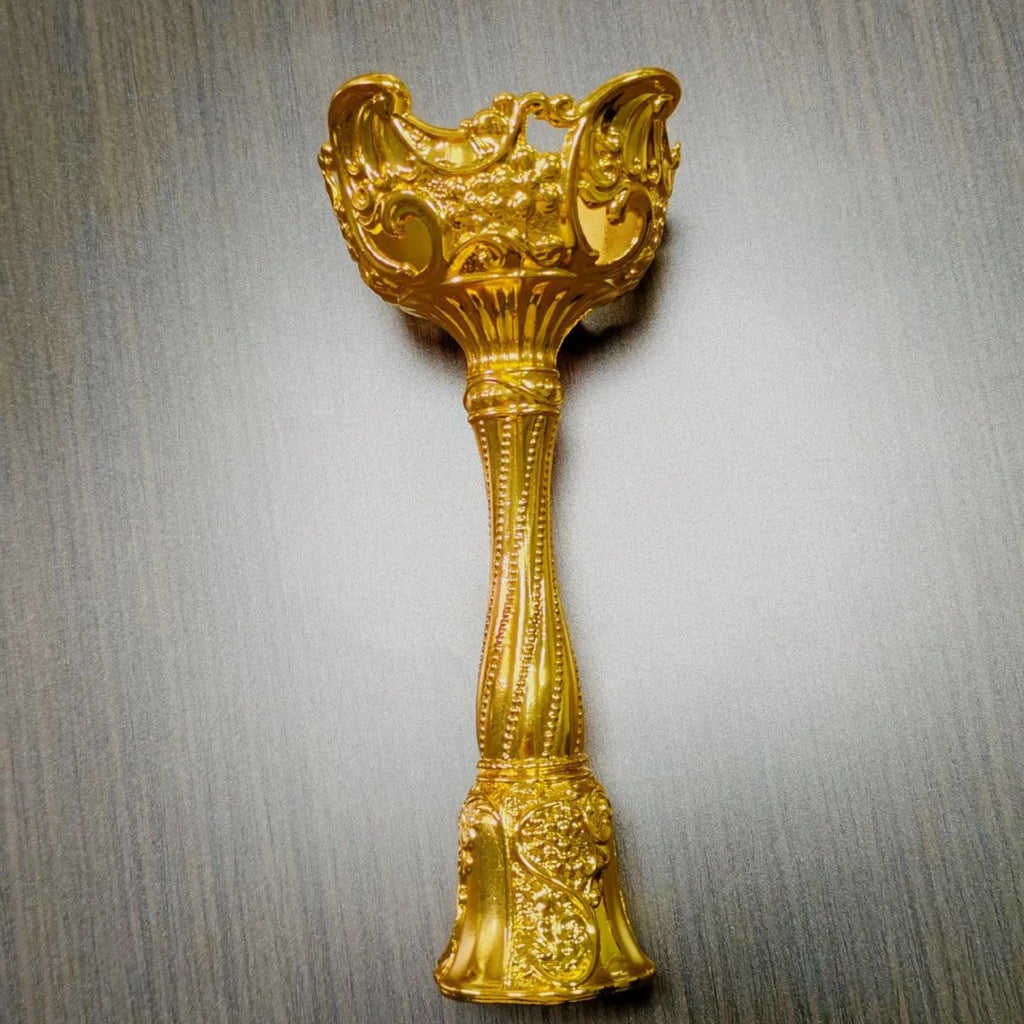 Small retro metal candlestick ornament in gold finish on a wedding table setting