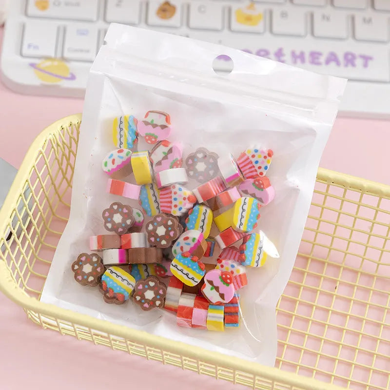Assortment of fifty small cartoon-shaped rubber erasers in fruit and animal designs.