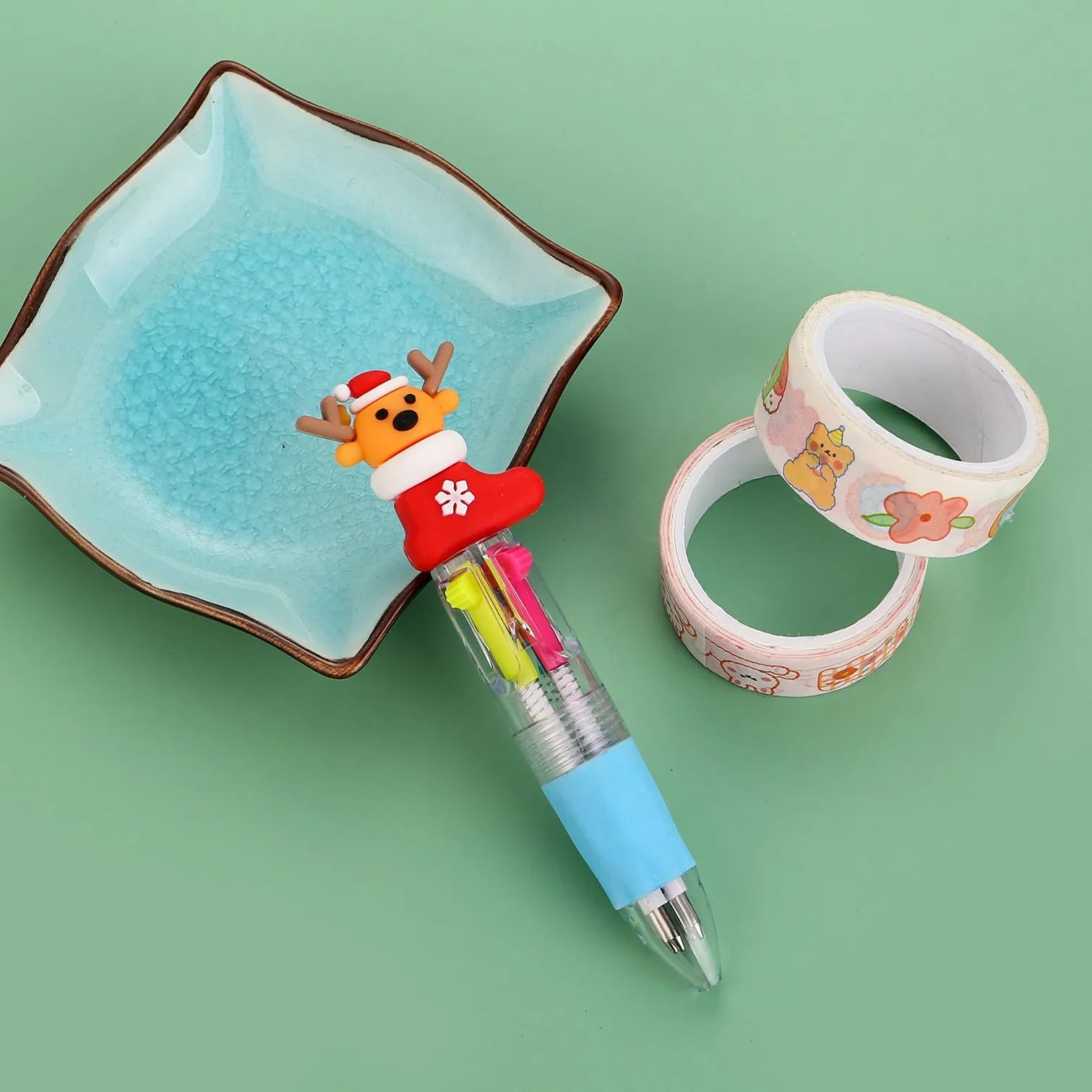Christmas mini four-colour press-type ballpoint pen showing festive designs, 11cm long.