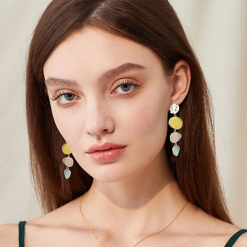 Morandi three-colour oil drip finish on a pair of simple alloy disc earrings with sterling silver posts.