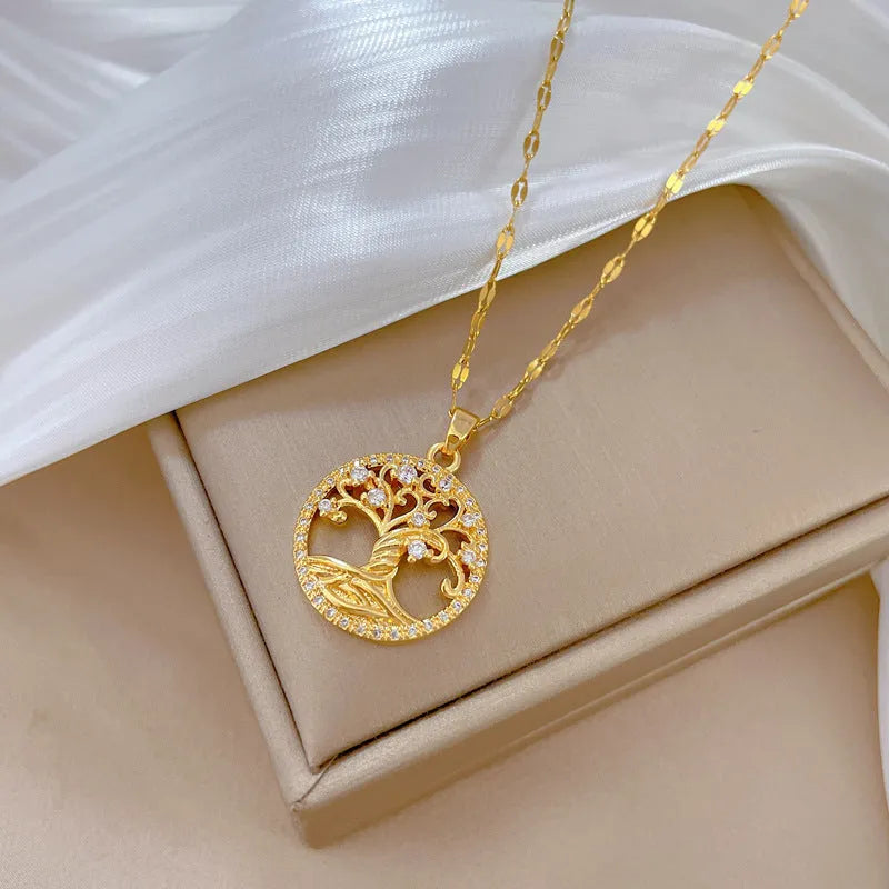Gold-plated cross necklace with mother pearl inlay and rhinestone detailing on adjustable chain