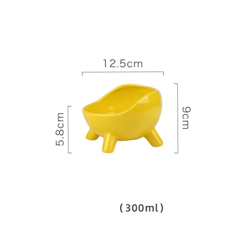 Green four-legged ceramic pet bowl for cats and small dogs on floor