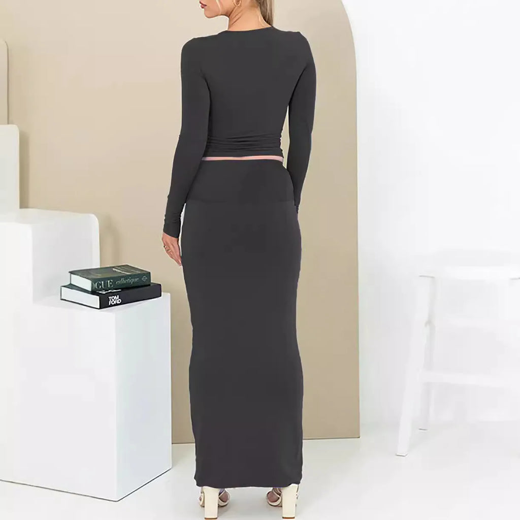 Women's black two-piece autumn suit featuring a crop top and long skirt in a slim fit.