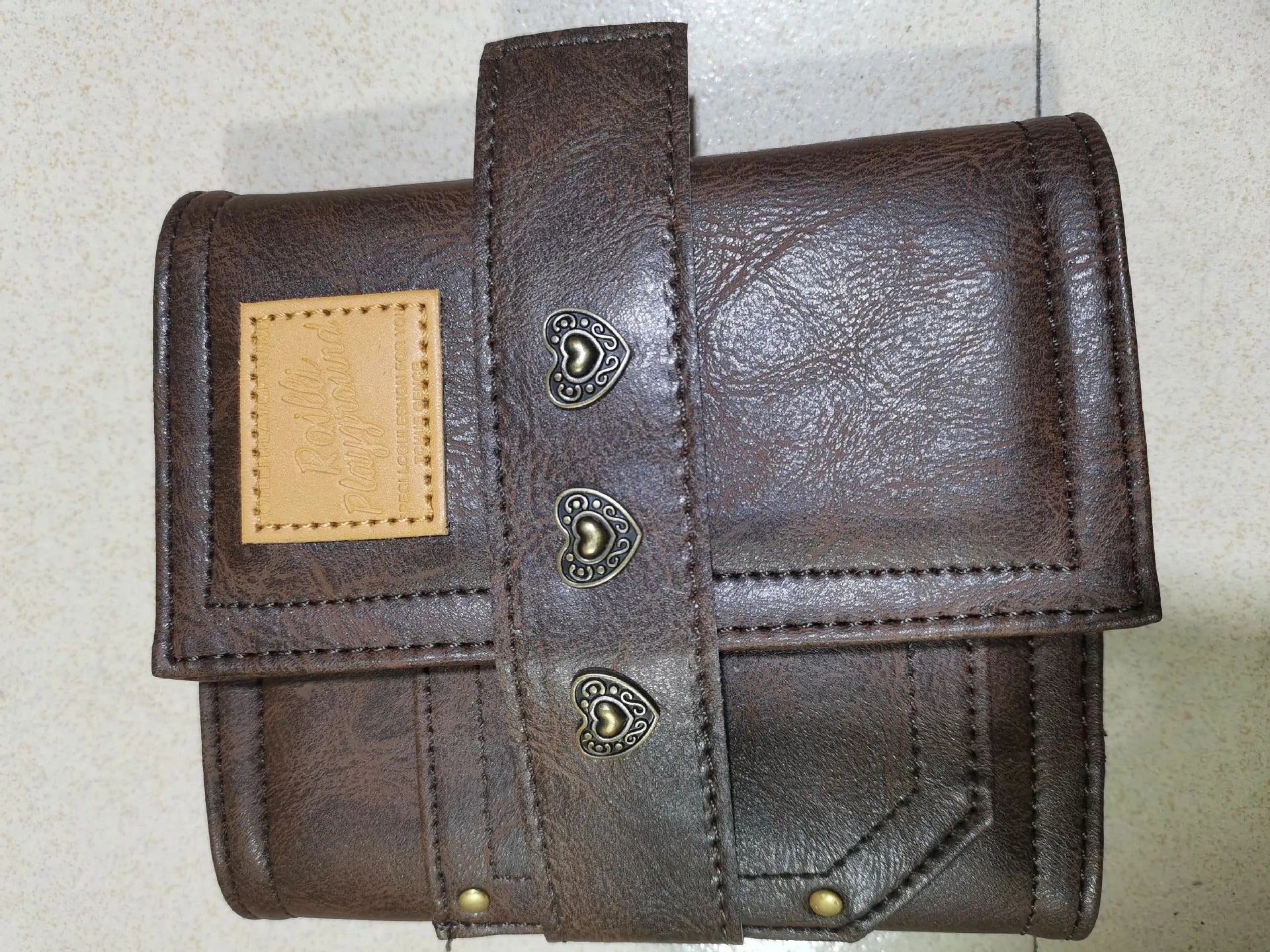 Brown retro leather-style A7 notebook with buckle closure and loose-leaf binding