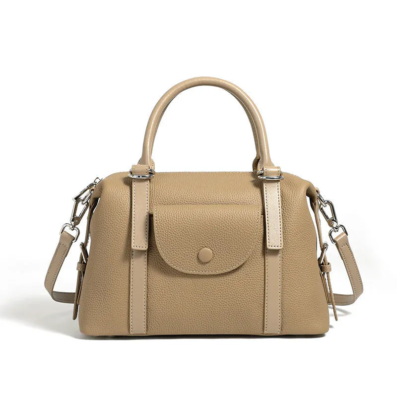 Genuine leather ladies handbag with lock detail in black, brown, or elephant grey.