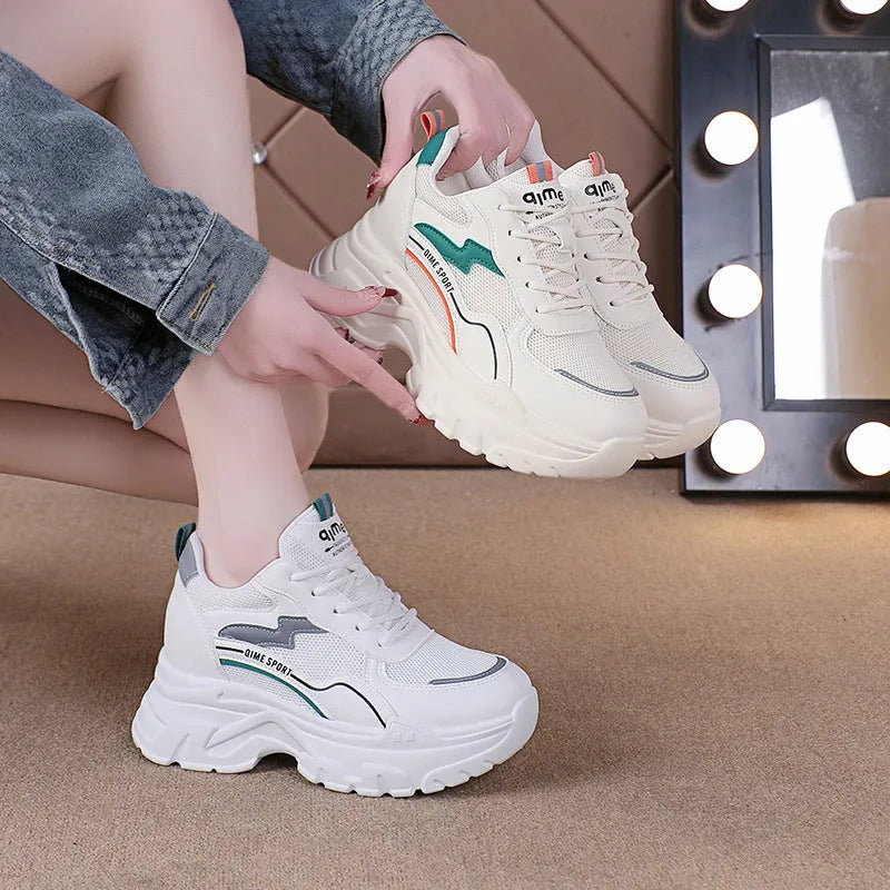 Women's white low-top dad shoes with cross straps and lace-up front